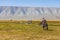 Altai, Mongolia - June 14, 2017: Mongolian nomad looks at tourists whose motorcycle is broken