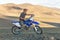 Altai, Mongolia - June 14, 2017: A satisfied motorcyclist is preparing a trip