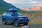 ALTAI, RUSSIA - AUGUST 12, 2015: Off-road vehicle at the mountain pass `Warm key` against backdrop of the mountains.