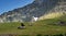 Altai, Russia - July 25, 2020: girl tourist with a backpack sits on the rocks in the mountains