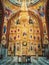 The altar and beautiful painted interior of the Curchi Monastery. Suspending golden chandelier with glowing lights. Different