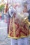 Altar boy or acolyte in the holy week procession shaking a censer to produce smoke and fragrance of incense