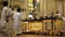 Altar boys march their candles in the church during mass celebration