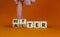 Alter or better symbol. Businessman turns wooden cubes and changes the word `alter` to `better`. Beautiful orange background,