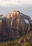 The Alter of Sacrifice in Zion National park with it`s red and yellow sandstone cliffs topped by snow