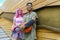 Alternative diverse couple hanging out together chilling and smiling standing against background wall. happy interracial friends