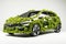 Alternative eco Grass covered car concept to power on a white background.