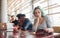 Alternative girl with green hair is sitting against group of multi ethnic people that working together by the table