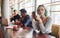 Alternative girl with green hair is sitting against group of multi ethnic people that working together by the table