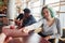 Alternative girl with green hair is sitting against group of multi ethnic people that working together by the table