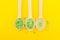 Alternative healthcare concept. Green Salt in three wooden spoons on a yellow background