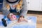 Alternative hipster travel young girl planning her next adventure trip on a island - paper old map on a wooden table and vintage