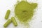 Alternative medicine, herbal pain management and opioid withdrawal treatment concept theme with a pile of green kratom powder and
