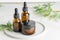 Alternative medicine, natural cosmetics. cbd oil, face cream in dark glass jar and cannabis leaves cosmetics on a tray
