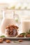 Alternative milk of almonds on white table in kitchen vertical