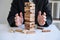Alternative Risk and Strategy in business, Business woman`s hands protect balance wooden stack with hand control risk shape