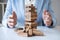 Alternative Risk and Strategy in business, Business woman`s hands protect balance wooden stack with hand control risk shape