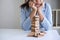 Alternative Risk and Strategy in Business, Image of Stressed, worry, Business woman gambling placing making wooden block hierarchy