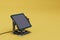 alternative ways to generate electricity. solar battery on a yellow background. 3d render