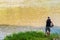 Althom, Pennsylvania, USA 8/10/2019 A man using a weed whacker to to trim grass along the Allegheny river in Warren county