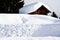 Altitude snow, wooden lodges, sky, winter in Dolomiti mountains, in Cadore, Italy