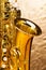 Alto saxophone with keys on silver background