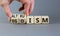 Altruism or egoism symbol. Concept words Egoism and Altruism on wooden cubes. Psychologist hand. Beautiful grey table grey