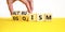 Altruism or egoism symbol. Concept words Egoism and Altruism on wooden cubes. Psychologist hand. Beautiful yellow table white