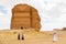 AlUla, Saudi Arabia, February 19 2020: Tourists from Saudi Arabia stand with ther guides in front of the tomb of Lihyan