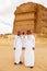 AlUla, Saudi Arabia, February 19 2020: Two young Saudi Arabian tour guides pose in front of the tomb of Lihyan