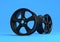 Aluminium alloy car wheel. Black alloy rim for car, tracks on blue background