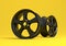 Aluminium alloy car wheel. black alloy rim for car, tracks on yellow background