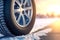 Aluminium alloy or steel auto wheel on the road. Close-up of a car wheel with a rubber tire for winter weather. Generative A