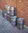 Aluminium Beer Barrels Against a Brick Wall