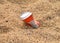 Aluminium drink container in sand