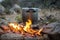 Aluminium pot being heated over outdoor camp fire
