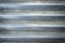 Aluminium striped line wave close-up abstract background. Steel metal zinc texture