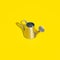 Aluminium watering can on bright yellow background. Minimal bold colored garden background. Gardening, growing, spring or summer
