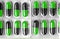 Aluminum blisters with colored black and green oval capsules neat flat lay