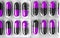 Aluminum blisters with colored black and purple oval capsules neat flat lay