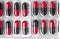 Aluminum blisters with colored black and red oval capsules neat flat lay