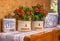 Aluminum boxes and decorative handmade vases with red alstroemeria flowers in the living room
