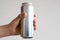 aluminum can with carbonated drink in a male hand.