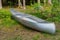 An aluminum canoe in a forest