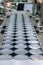 Aluminum cans for food processed in factory line conveyor machine at canned food manufacturing, selective focus