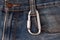 Aluminum carabiner hanging on jeans