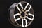 Aluminum die cast alloy wheel for powerful SUV close up on black background. polished surface