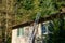 Aluminum extension ladder propped up against the roof of an apartment building, sunny fall day