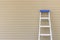 An aluminum foldable ladder  on the wall