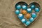 Aluminum heart form and glasses on brown cloth